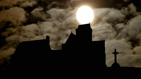 Iona Abbey silhouetted against a moonlit sky