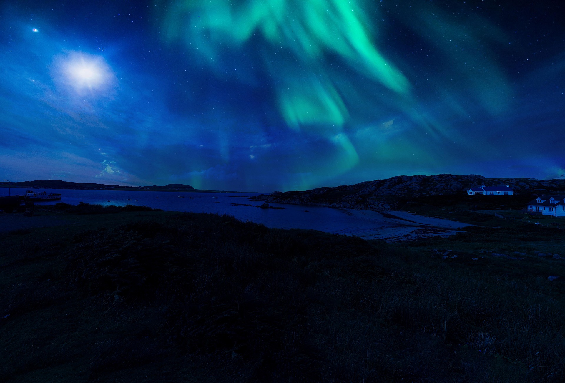 Aurora borealis over the Scottish coast at night
